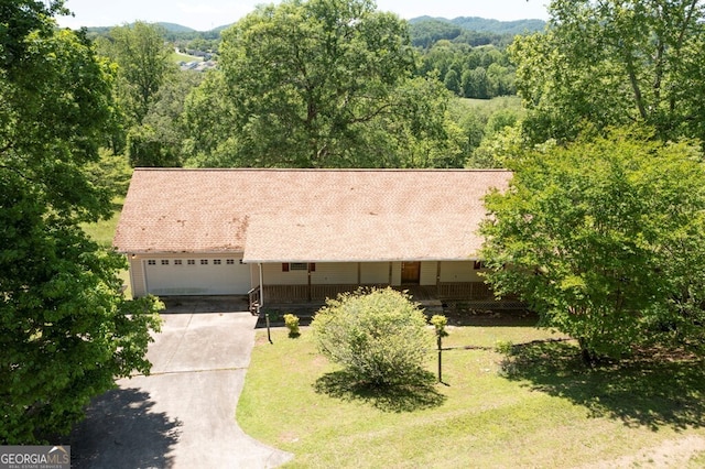 156 Spoon Hill Dr, Hayesville, NC 28904 - view of front facade with concrete driveway, an attached garage, a porch, a front yard, and a wooded view