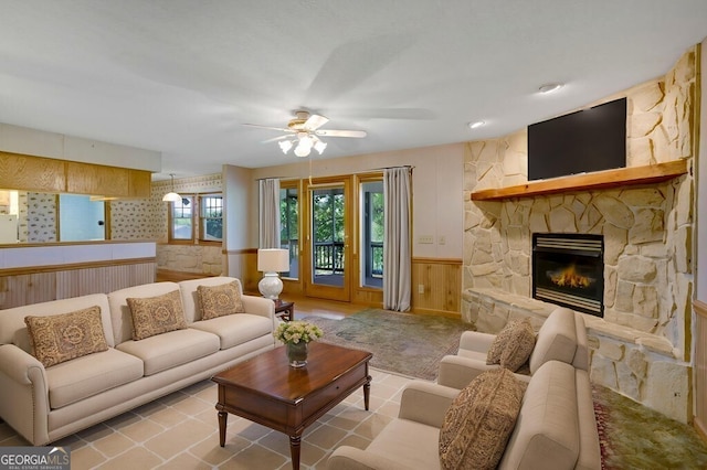 156 Spoon Hill Dr, Hayesville, NC 28904 - living area featuring ceiling fan, wainscoting, a fireplace, and wooden walls
