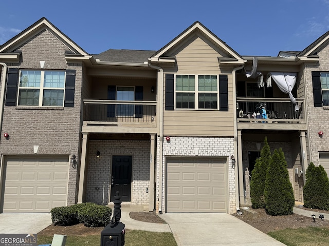 1853 Broad River Rd, Atlanta, GA 30349 - townhome / multi-family property featuring a balcony, a garage, brick siding, and concrete driveway