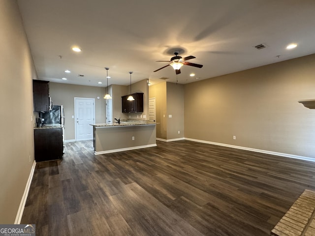 1853 Broad River Rd, Atlanta, GA 30349 - unfurnished living room with a ceiling fan, baseboards, dark wood-style flooring, recessed lighting, and a sink