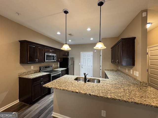 1853 Broad River Rd, Atlanta, GA 30349 - kitchen with stainless steel appliances, a sink, dark wood-style flooring, a peninsula, and dark brown cabinetry