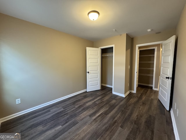 1853 Broad River Rd, Atlanta, GA 30349 - unfurnished bedroom with dark wood finished floors, baseboards, and a closet
