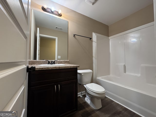 1853 Broad River Rd, Atlanta, GA 30349 - bathroom with wood finished floors, toilet, vanity, and bathing tub / shower combination