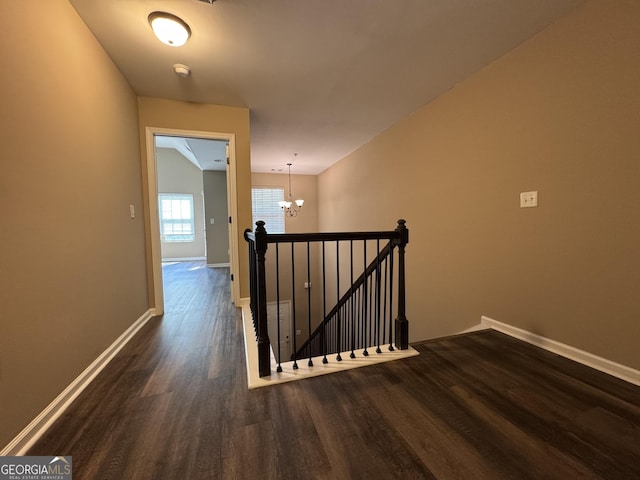 1853 Broad River Rd, Atlanta, GA 30349 - hallway with an upstairs landing, dark wood-style flooring, a chandelier, and baseboards