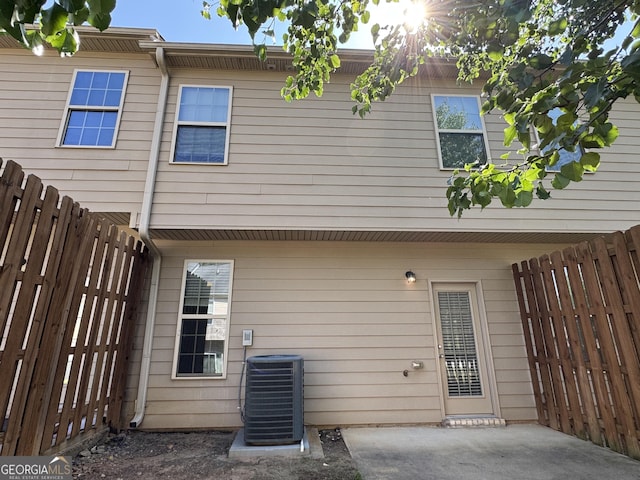 1853 Broad River Rd, Atlanta, GA 30349 - rear view of property with cooling unit, a fenced backyard, and a patio area