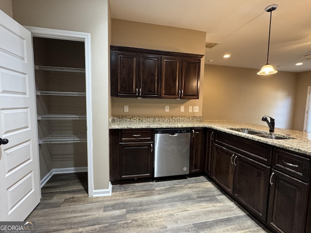1853 Broad River Rd, Atlanta, GA 30349 - kitchen featuring stainless steel dishwasher, a sink, light wood-style floors, light stone countertops, and dark brown cabinets