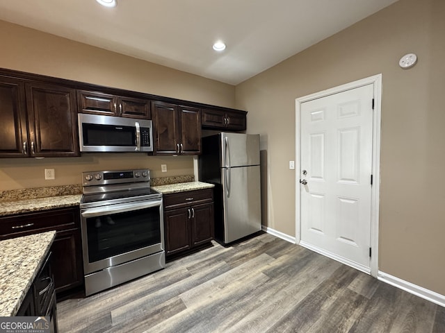 1853 Broad River Rd, Atlanta, GA 30349 - kitchen with stainless steel appliances, light wood-style floors, dark brown cabinetry, light stone counters, and recessed lighting