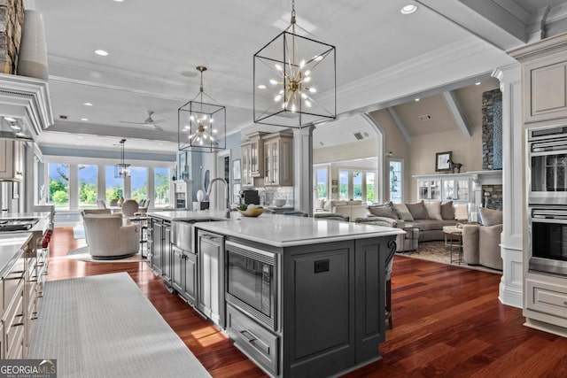 1461 N Shore Dr, Greensboro, GA 30642 - kitchen with built in microwave, a sink, a large island with sink, a chandelier, and open floor plan