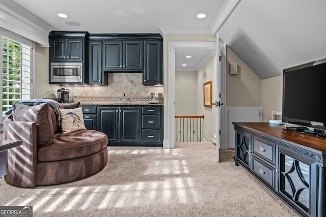 1461 N Shore Dr, Greensboro, GA 30642 - kitchen with stainless steel microwave, carpet floors, dark countertops, crown molding, and decorative backsplash