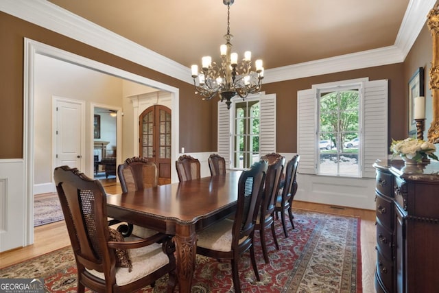 13037 Overlook Pass, Roswell, GA 30075 - dining area featuring a chandelier, crown molding, light wood-style floors, and french doors