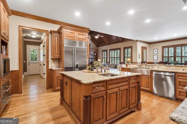 13037 Overlook Pass, Roswell, GA 30075 - kitchen featuring built in appliances, a sink, light wood-style floors, an island with sink, and crown molding
