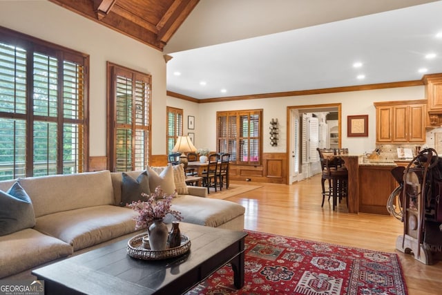 13037 Overlook Pass, Roswell, GA 30075 - living room with wainscoting, light wood-type flooring, recessed lighting, vaulted ceiling, and ornamental molding