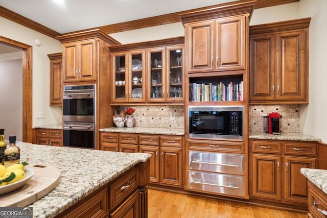 13037 Overlook Pass, Roswell, GA 30075 - kitchen with built in microwave, double oven, decorative backsplash, light stone countertops, and crown molding