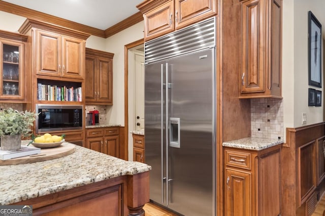 13037 Overlook Pass, Roswell, GA 30075 - kitchen featuring built in appliances, brown cabinetry, tasteful backsplash, and ornamental molding