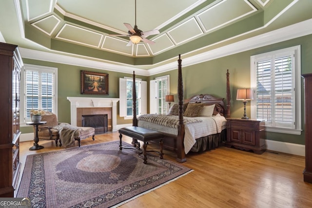 13037 Overlook Pass, Roswell, GA 30075 - bedroom with crown molding, a tiled fireplace, multiple windows, a tray ceiling, and baseboards