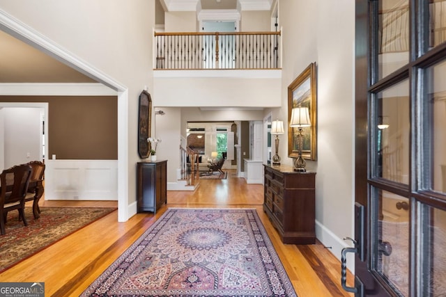 13037 Overlook Pass, Roswell, GA 30075 - foyer entrance featuring wood finished floors, ornamental molding, wainscoting, a high ceiling, and french doors