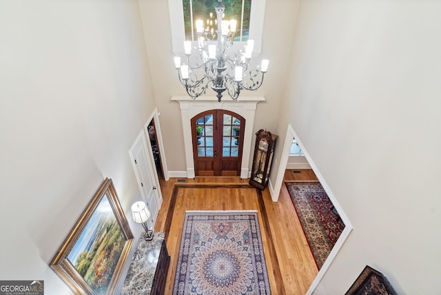 13037 Overlook Pass, Roswell, GA 30075 - entrance foyer with a chandelier, wood finished floors, french doors, a towering ceiling, and baseboards
