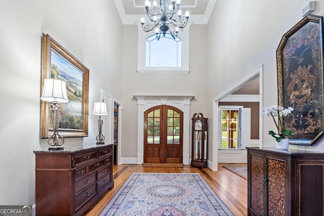 13037 Overlook Pass, Roswell, GA 30075 - entrance foyer with light wood-style floors, a chandelier, plenty of natural light, a towering ceiling, and ornamental molding
