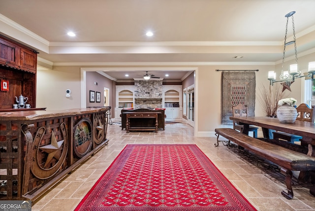13037 Overlook Pass, Roswell, GA 30075 - living area with ceiling fan, stone tile floors, crown molding, a stone fireplace, and baseboards