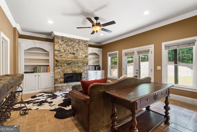 13037 Overlook Pass, Roswell, GA 30075 - living area featuring built in features, crown molding, ceiling fan, stone tile flooring, and a stone fireplace