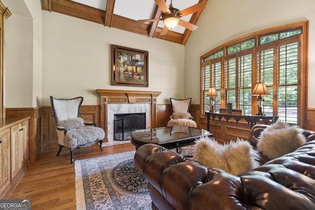 13037 Overlook Pass, Roswell, GA 30075 - living room with wainscoting, wood finished floors, a high end fireplace, ceiling fan, and wooden walls