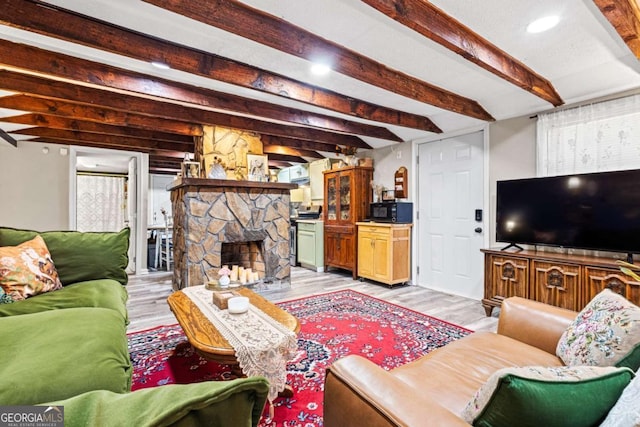 251 Lang St, Griffin, GA 30223 - living room with light wood-style floors, beam ceiling, a stone fireplace, and recessed lighting