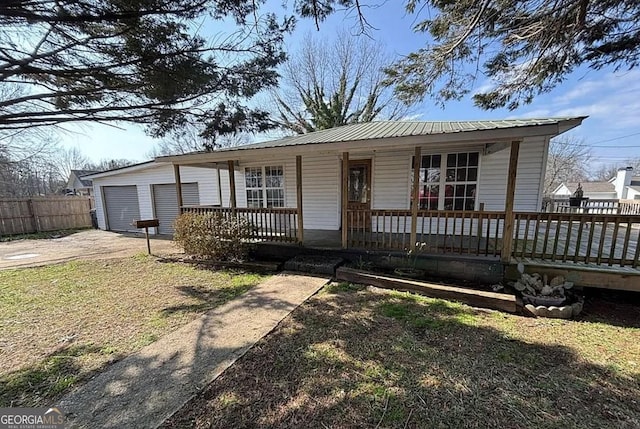 6205 Helen St, Lula, GA 30554 - single story home with a porch, concrete driveway, metal roof, and an attached garage