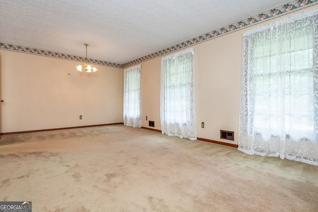 3549 Dogwood Dr, Powder Springs, GA 30127 - unfurnished room featuring a chandelier, baseboards, carpet, and a textured ceiling