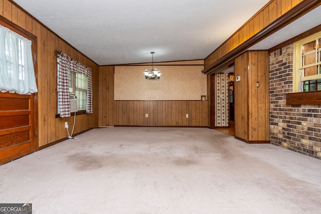 3549 Dogwood Dr, Powder Springs, GA 30127 - carpeted spare room featuring a chandelier, wooden walls, baseboards, and ornamental molding
