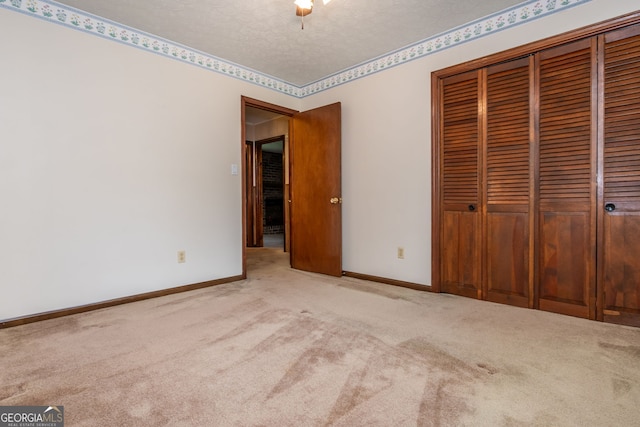 3549 Dogwood Dr, Powder Springs, GA 30127 - unfurnished bedroom with carpet floors, a closet, baseboards, and a textured ceiling