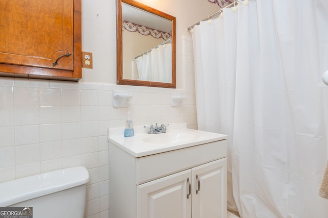 3549 Dogwood Dr, Powder Springs, GA 30127 - bathroom with tile walls, vanity, toilet, a wainscoted wall, and curtained shower