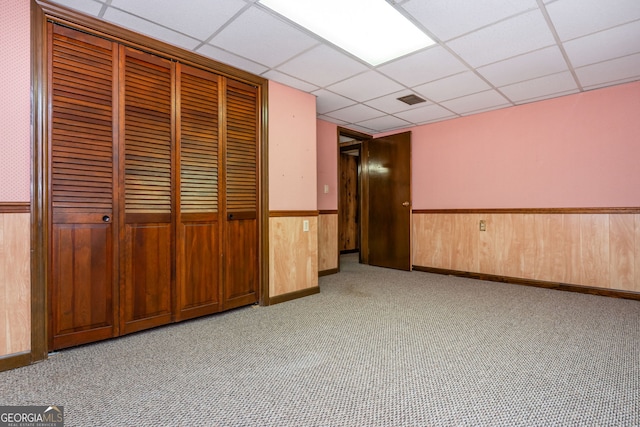 3549 Dogwood Dr, Powder Springs, GA 30127 - hallway featuring a paneled ceiling, wainscoting, wooden walls, and carpet flooring