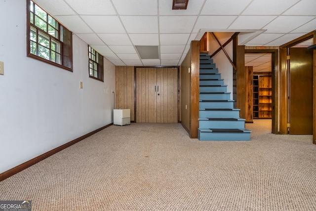 3549 Dogwood Dr, Powder Springs, GA 30127 - basement featuring stairs, carpet flooring, wood walls, baseboards, and a drop ceiling