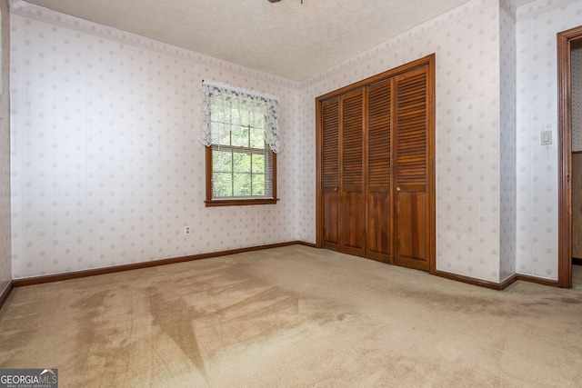3549 Dogwood Dr, Powder Springs, GA 30127 - unfurnished bedroom featuring carpet, a closet, and a textured ceiling