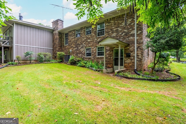 3549 Dogwood Dr, Powder Springs, GA 30127 - rear view of house featuring a chimney, a yard, brick siding, cooling unit, and board and batten siding