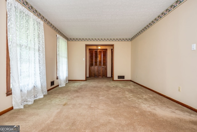 3549 Dogwood Dr, Powder Springs, GA 30127 - unfurnished room featuring baseboards, light carpet, and a textured ceiling