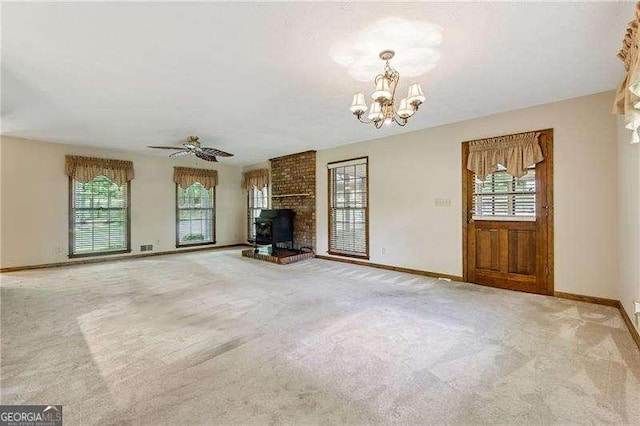 2270 Dinsmore Rd, Alpharetta, GA 30004 - unfurnished living room featuring a chandelier, baseboards, carpet flooring, a wood stove, and ceiling fan