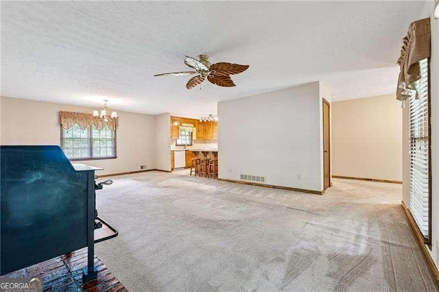 2270 Dinsmore Rd, Alpharetta, GA 30004 - unfurnished living room featuring a chandelier, ceiling fan, baseboards, light carpet, and a textured ceiling