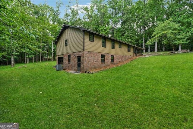 2270 Dinsmore Rd, Alpharetta, GA 30004 - view of property exterior with central AC, a yard, and brick siding