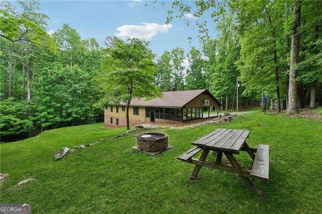 2270 Dinsmore Rd, Alpharetta, GA 30004 - view of community featuring a lawn and an outdoor fire pit