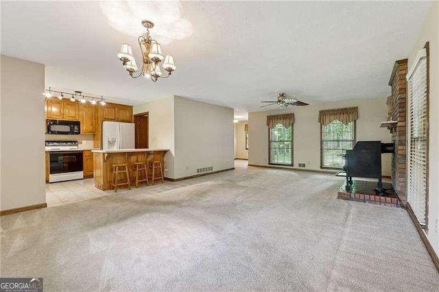 2270 Dinsmore Rd, Alpharetta, GA 30004 - unfurnished living room with light colored carpet, a chandelier, track lighting, a ceiling fan, and baseboards