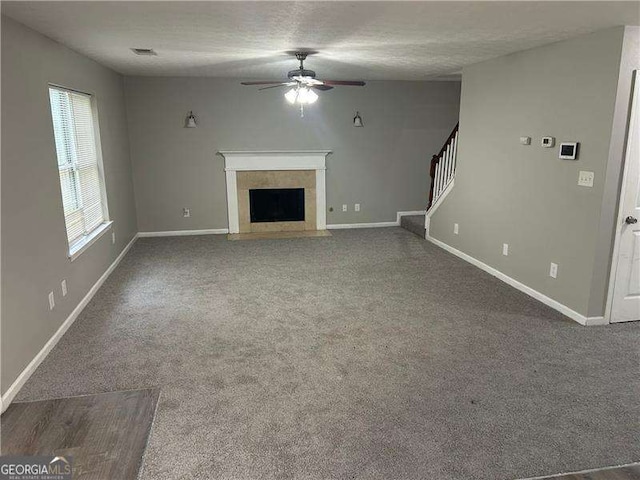 5755 Belmont Ridge Cir, Lithonia, GA 30038 - unfurnished living room featuring ceiling fan, carpet, a fireplace with flush hearth, and stairway