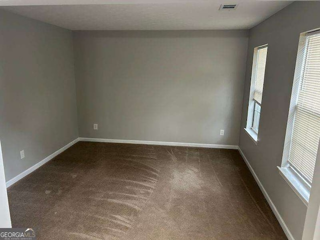 5755 Belmont Ridge Cir, Lithonia, GA 30038 - empty room with healthy amount of natural light and dark carpet
