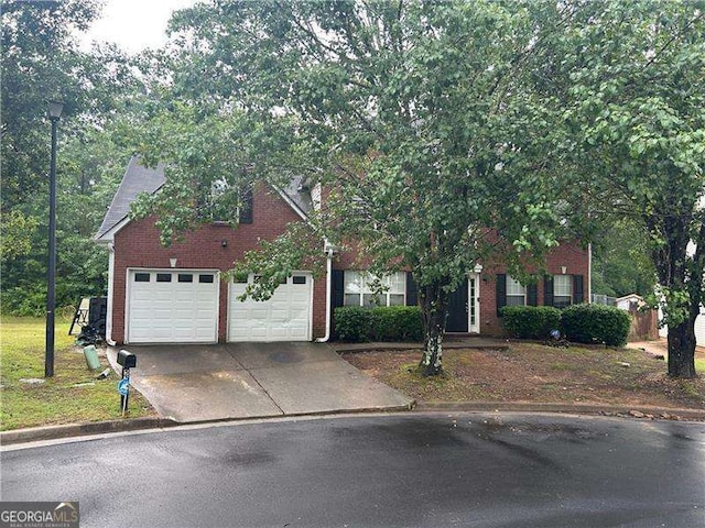 5755 Belmont Ridge Cir, Lithonia, GA 30038 - view of property hidden behind natural elements with concrete driveway, brick siding, and a garage