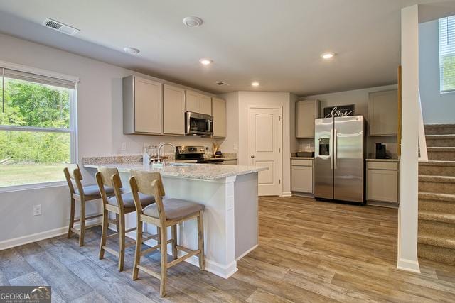 306 Cody Dr, Macon, GA 31216 - kitchen featuring stainless steel appliances, gray cabinets, a peninsula, light wood finished floors, and recessed lighting