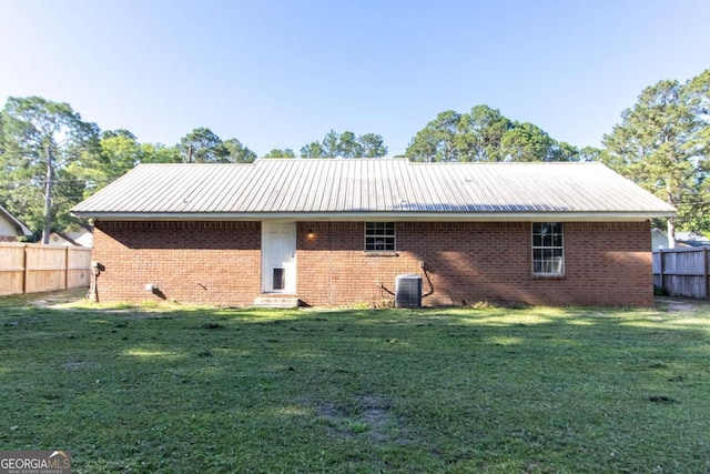 128 Deann Dr, Hinesville, GA 31313 - back of house featuring brick siding, metal roof, cooling unit, and entry steps