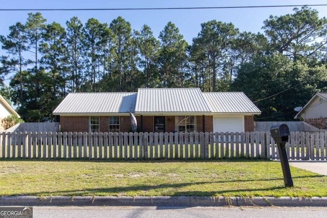 128 Deann Dr, Hinesville, GA 31313 - single story home featuring a garage, brick siding, driveway, and metal roof