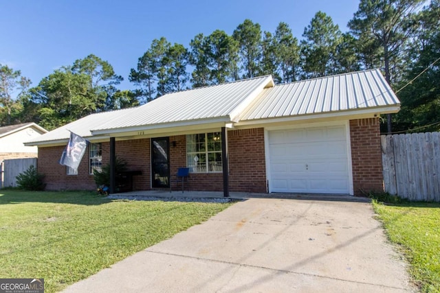 128 Deann Dr, Hinesville, GA 31313 - single story home featuring an attached garage, concrete driveway, brick siding, and metal roof