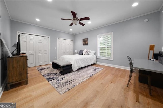 68 Edwin Pl, Atlanta, GA 30318 - bedroom with two closets, ornamental molding, light wood finished floors, recessed lighting, and baseboards