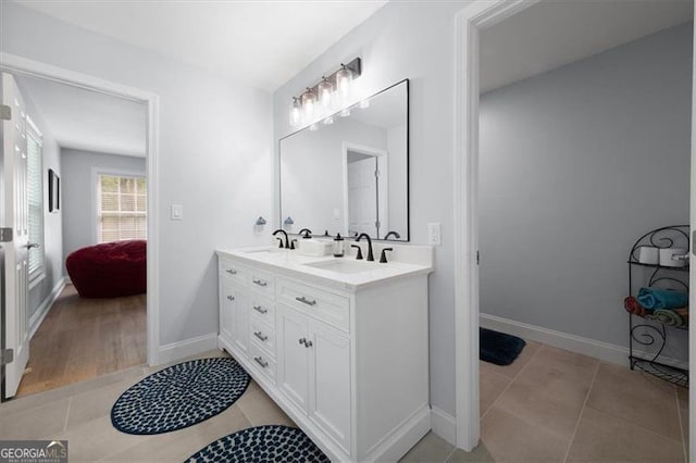 68 Edwin Pl, Atlanta, GA 30318 - bathroom with double vanity, tile patterned floors, and baseboards